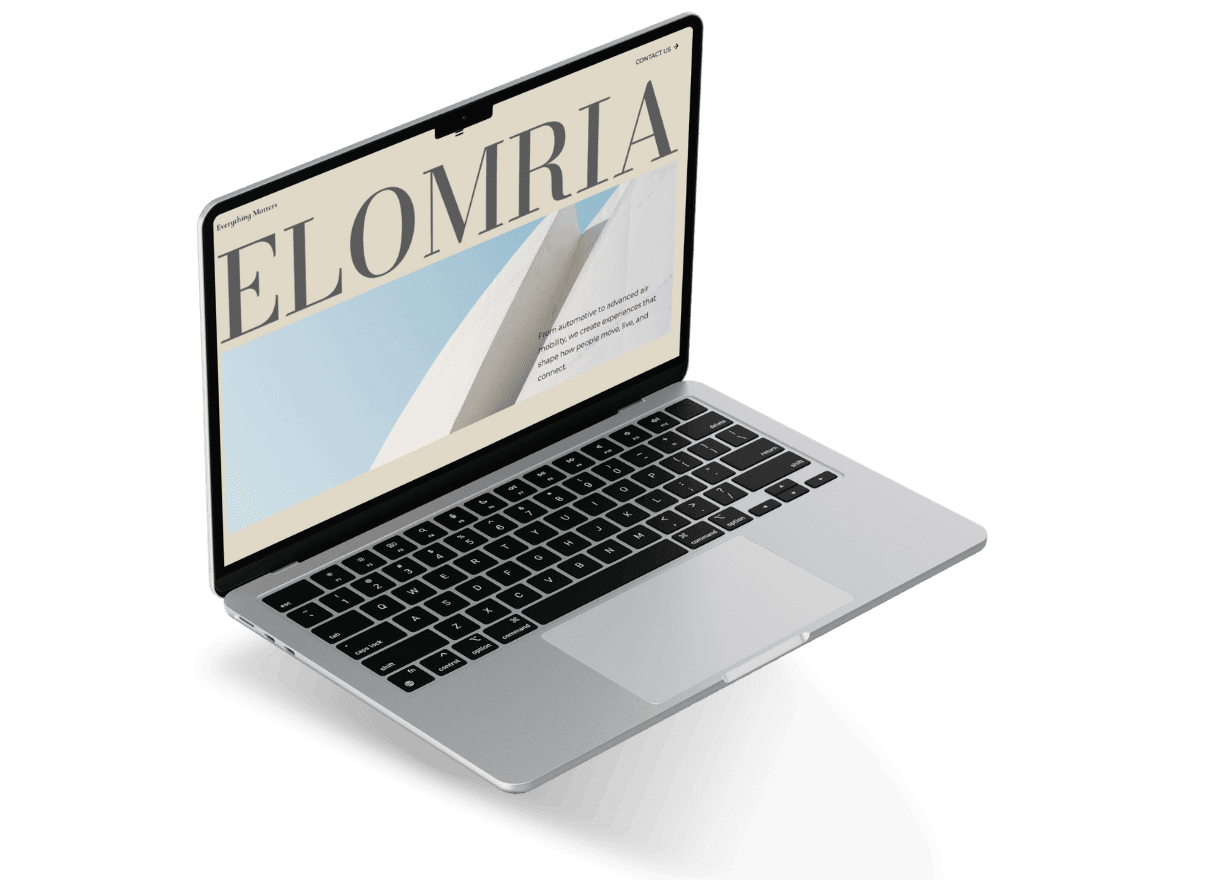 Angled laptop mockup showing the Elomria homepage with large “ELOMRIA” text and geometric visuals.