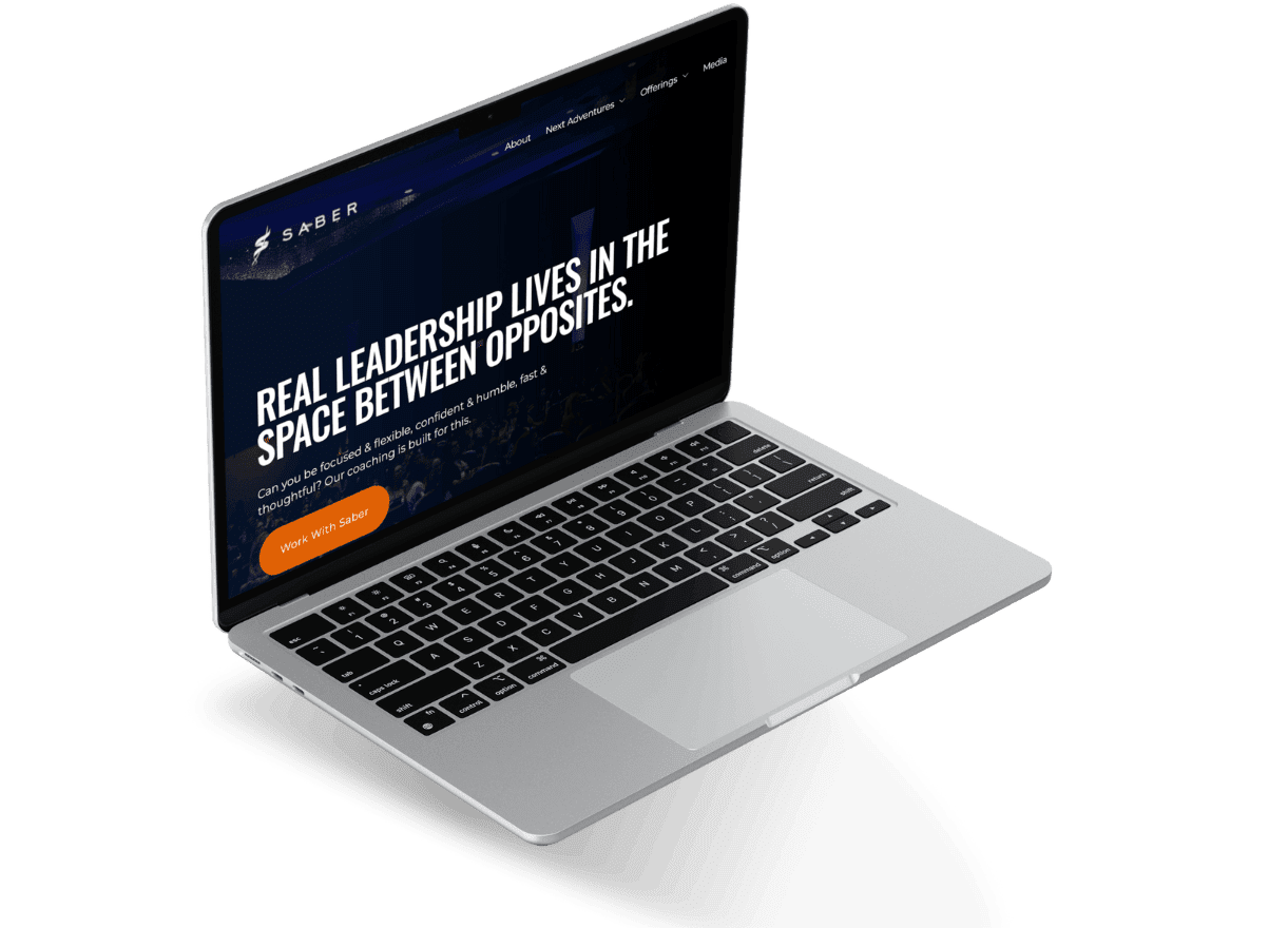 Laptop showing the Saber coaching homepage with a bold leadership headline and “Work With Saber” button.